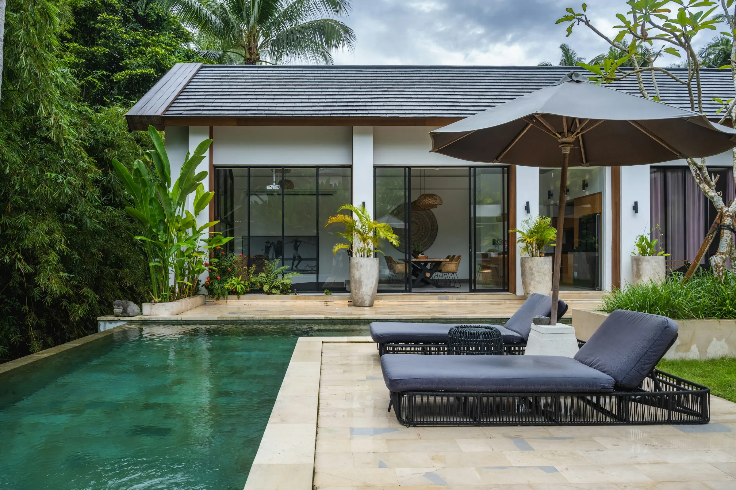 Pool and loungers in front of the house at Rumah Garam