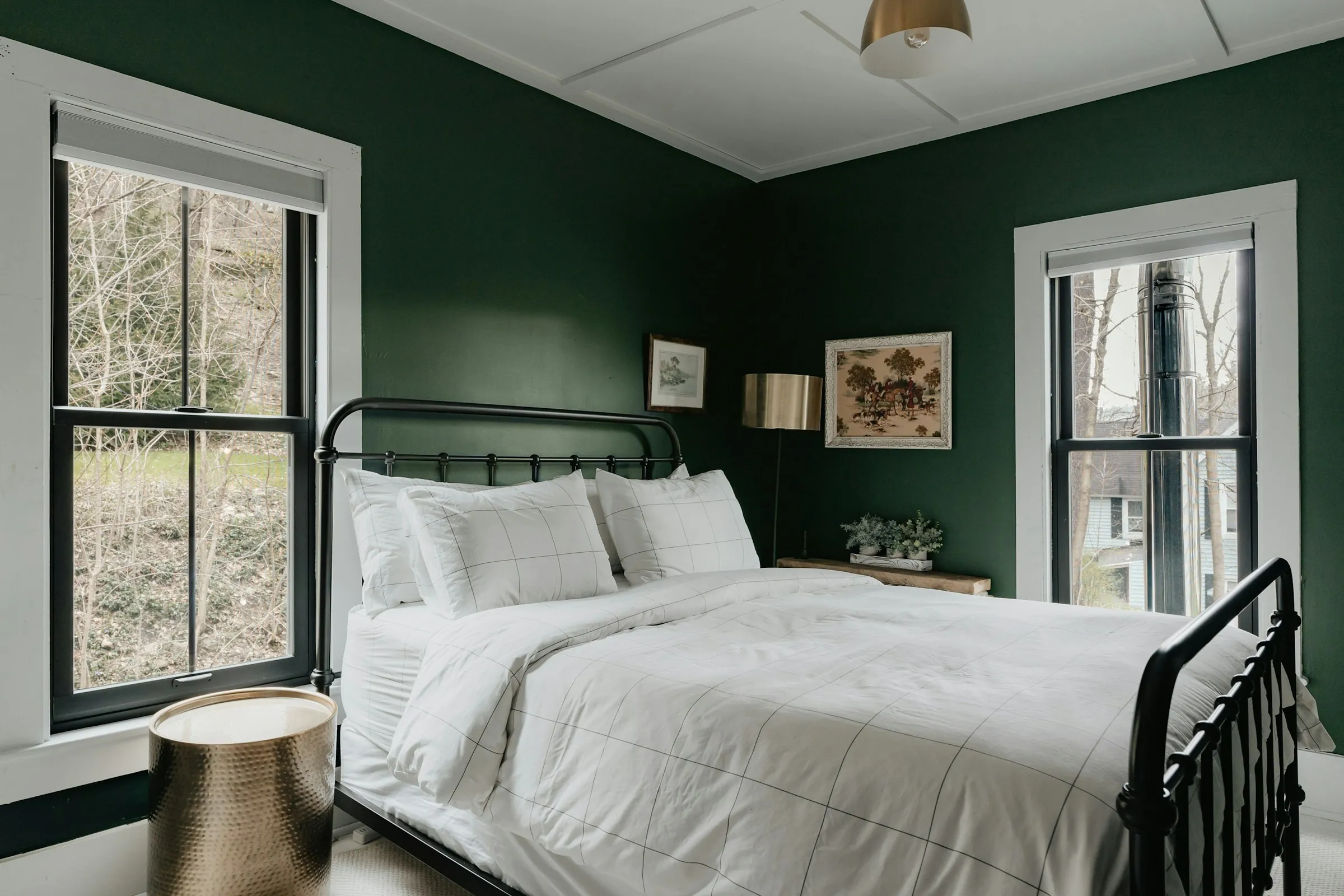 Deep green bedroom at Rumah Kabut with windows onto the trees